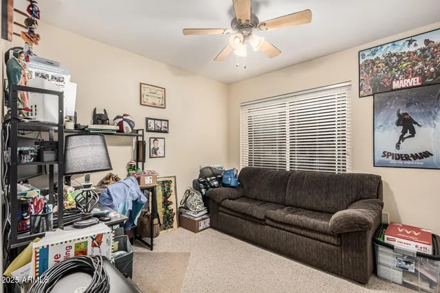 a living room with furniture a flat screen tv and a window