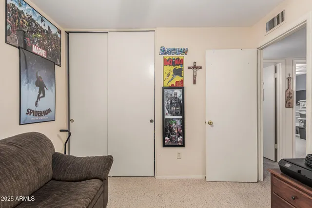 a living room with furniture and a wall painting