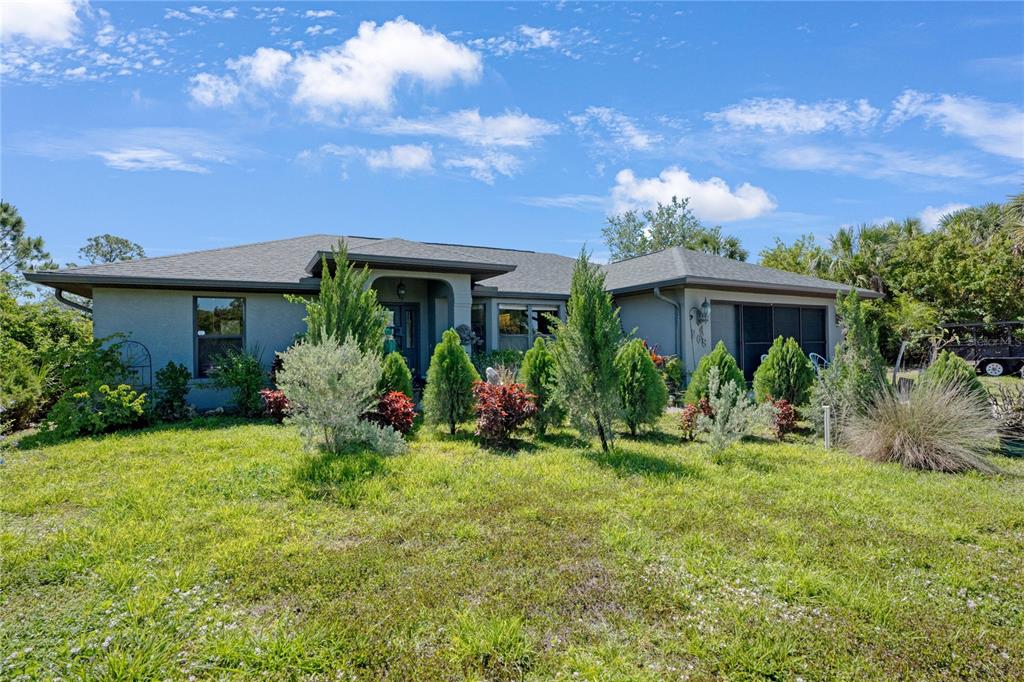 268 Cory Street Port Charlotte, FL 33953 - Photo 1 of 25 a view of a house with a yard and potted plants