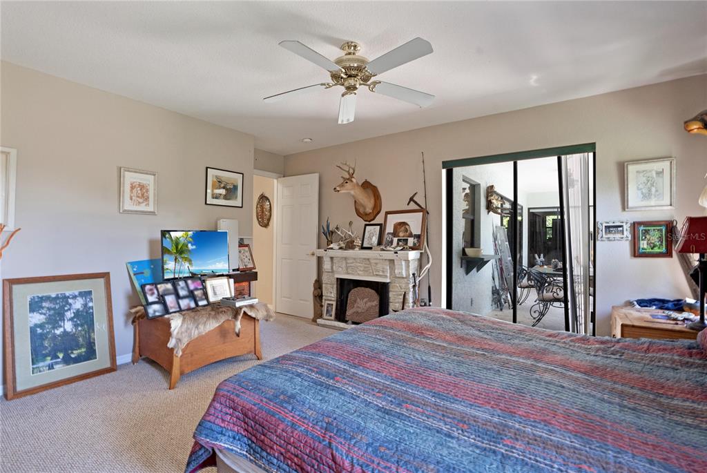 268 Cory Street Port Charlotte, FL 33953 - Photo 15 of 25 a bedroom with a bed fireplace and a chandelier