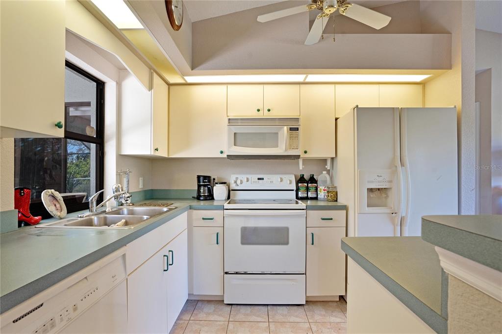 268 Cory Street Port Charlotte, FL 33953 - Photo 8 of 25 a kitchen with stainless steel appliances granite countertop a sink a stove and a refrigerator