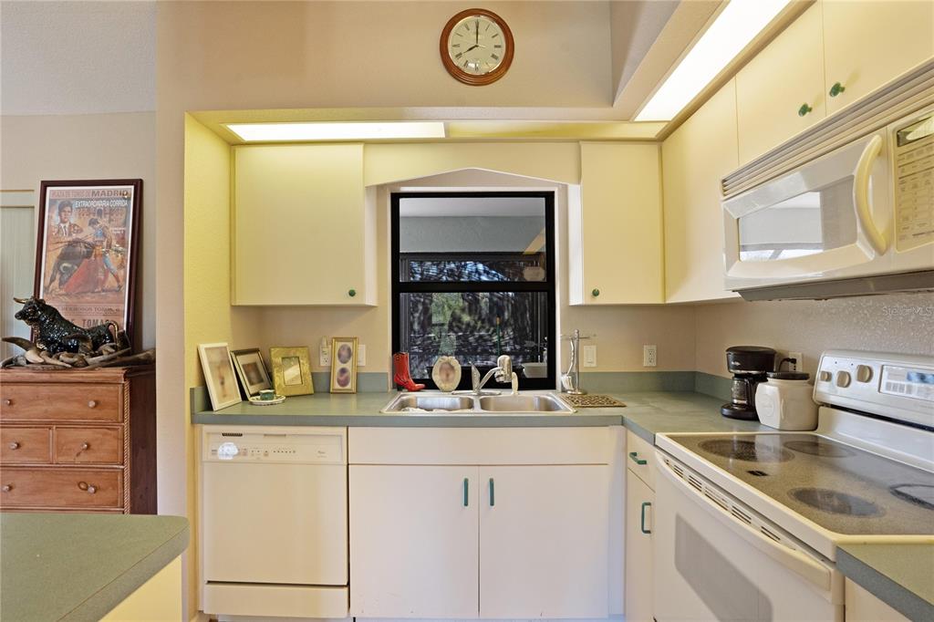 268 Cory Street Port Charlotte, FL 33953 - Photo 10 of 25 a kitchen with a sink cabinets and a window