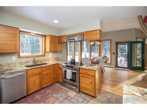 a en suite bathroom with a granite countertop sink and a