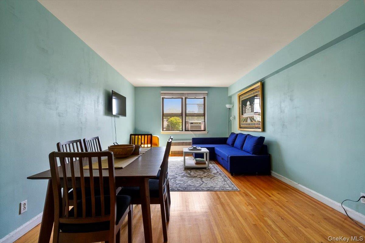 142 Garth Road, Unit 2H Scarsdale, NY 10583 - Photo 5 of 14 Dining space with light wood finished floors and radiator heating unit