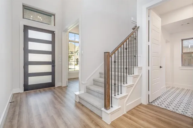 a view of entryway with wooden floor and stairs