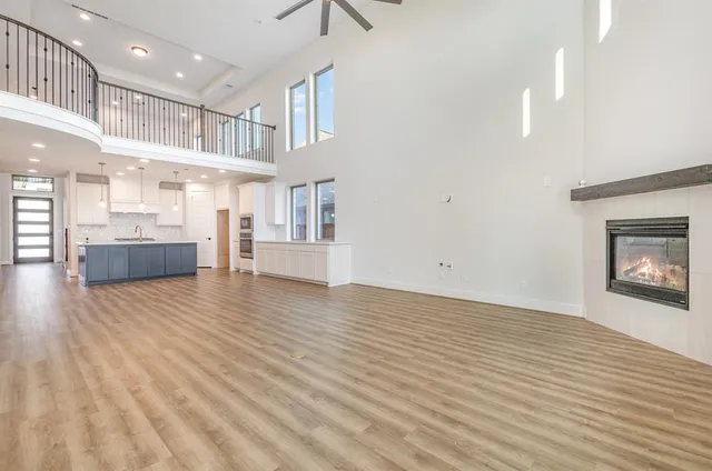 a view of kitchen and hall with wooden floor
