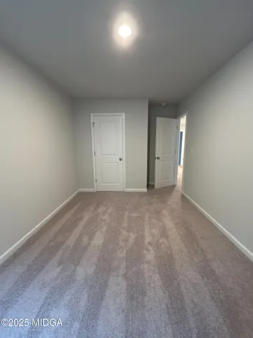 a view of an empty room and a window