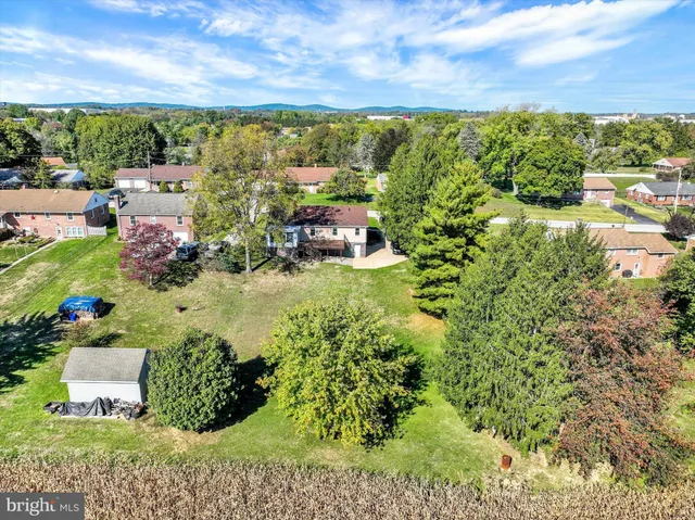 an aerial view of a house with a yard and lake view