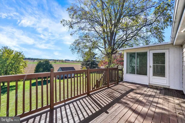 a balcony with wooden floor and fence