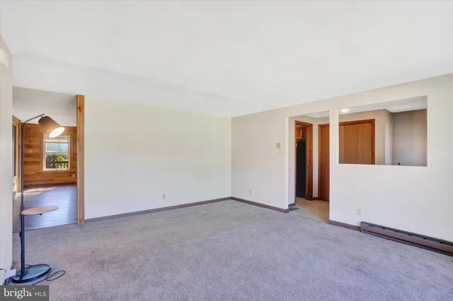 a view of a room with wooden floor and window