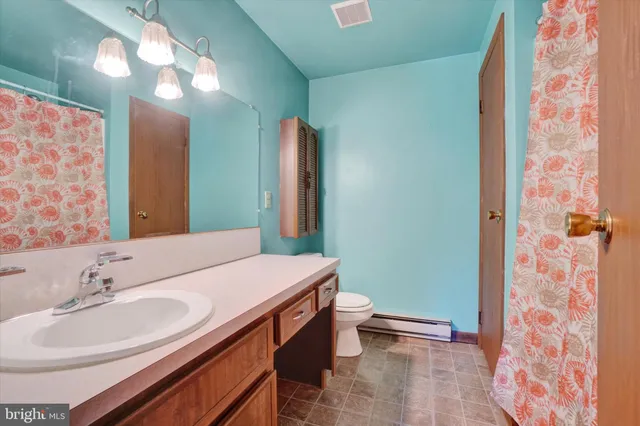 a view of a room with a window and a ceiling fan