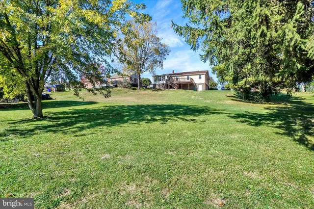 a view of a house with a yard and furniture