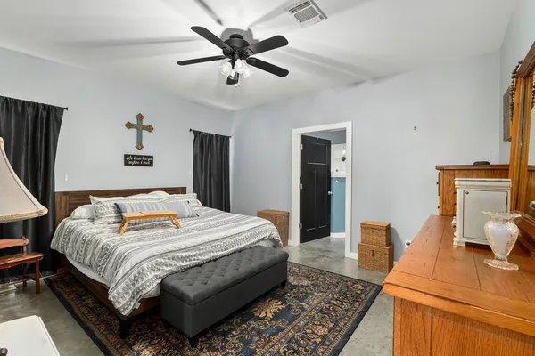 a bedroom with a large bed and a chandelier