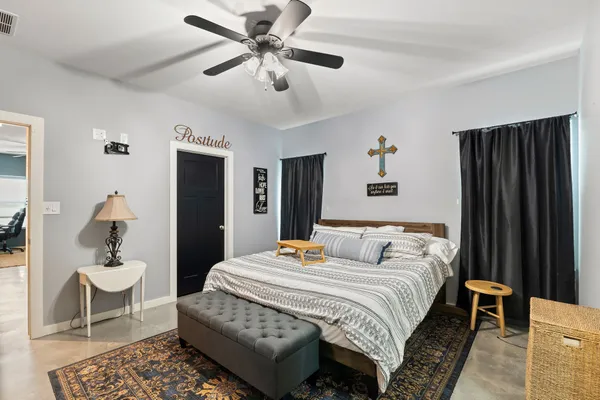 a bedroom with a bed and a table with closet