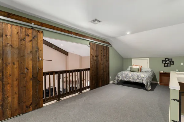 a spacious bedroom with a bed and a window