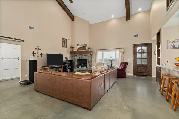 a living room with furniture a flat screen tv and a fireplace