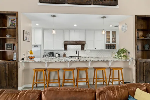 a kitchen with granite countertop lots of counter top space and windows