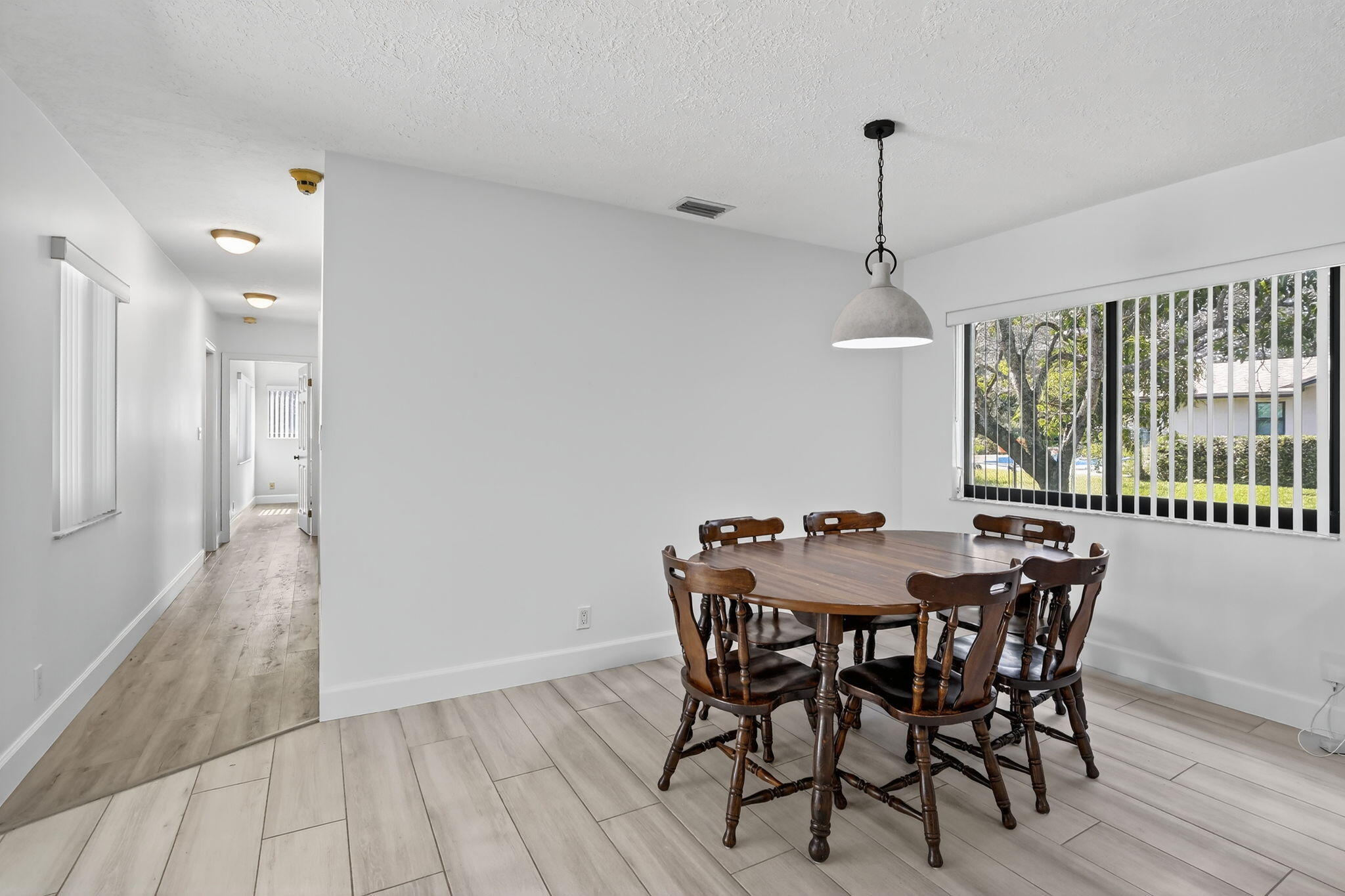 13150 Southwest 16th Court Davie, FL 33325 - Photo 18 of 59 a view of a dining room with furniture window and wooden floor