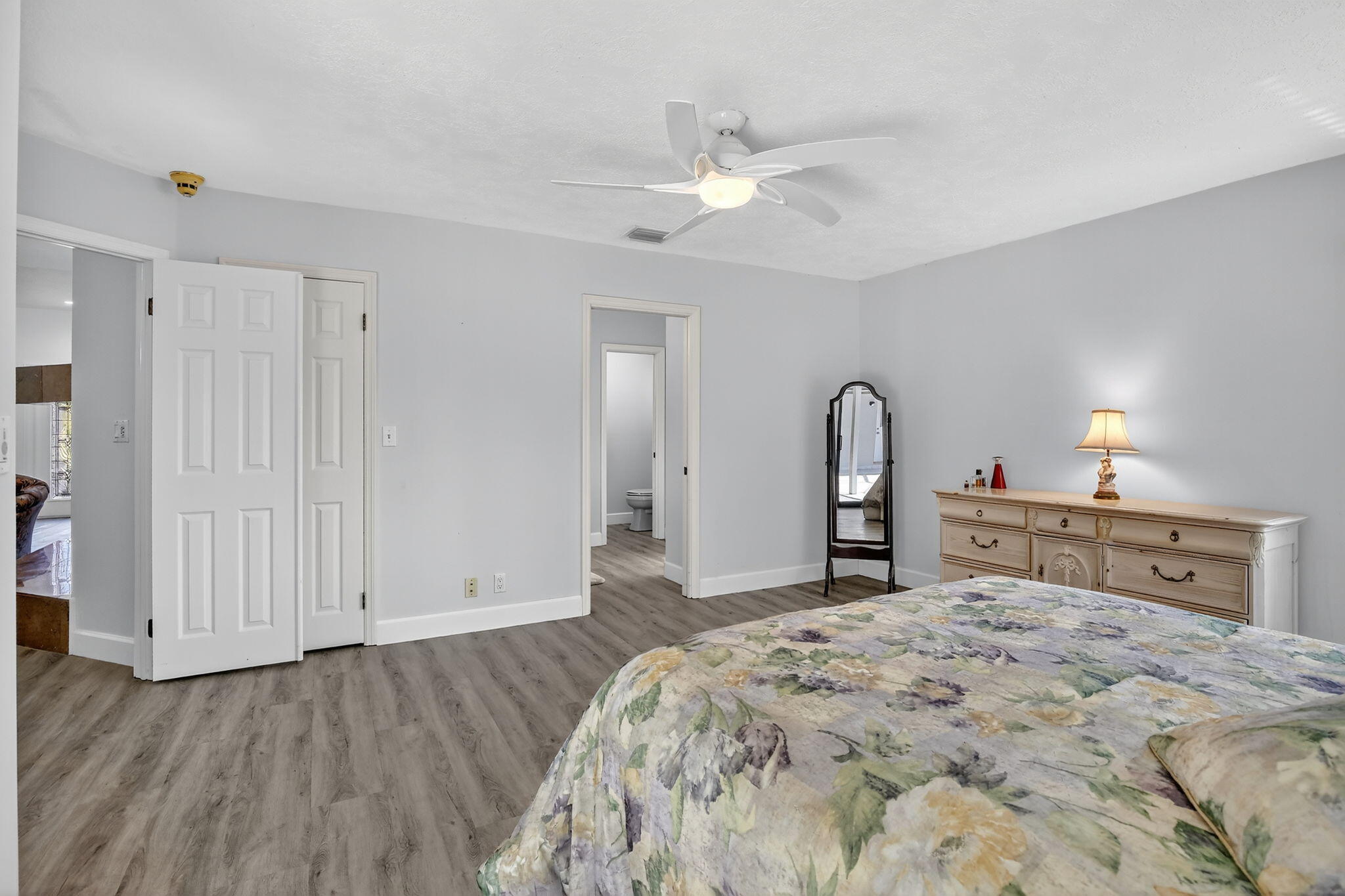 13150 Southwest 16th Court Davie, FL 33325 - Photo 22 of 59 a bedroom with a bed and a chandelier