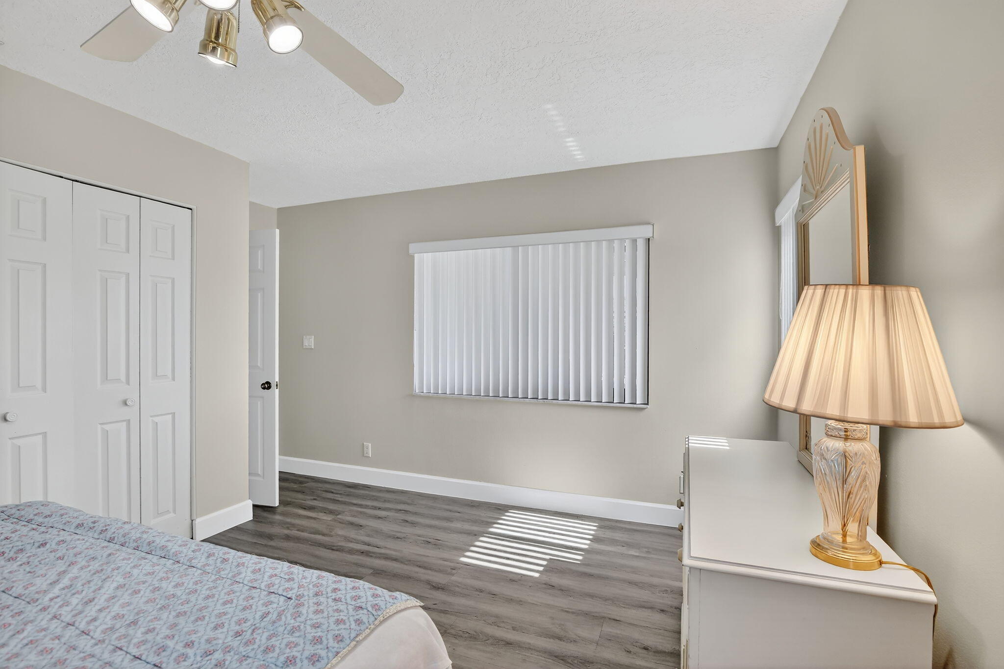 13150 Southwest 16th Court Davie, FL 33325 - Photo 27 of 59 a bedroom with a bed and a lamp on the dresser