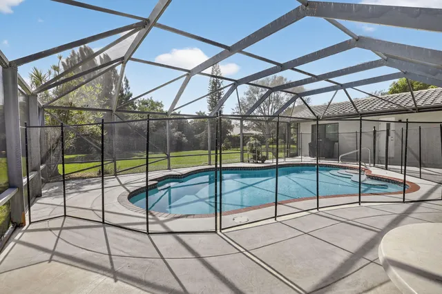 a view of a swimming pool and a yard