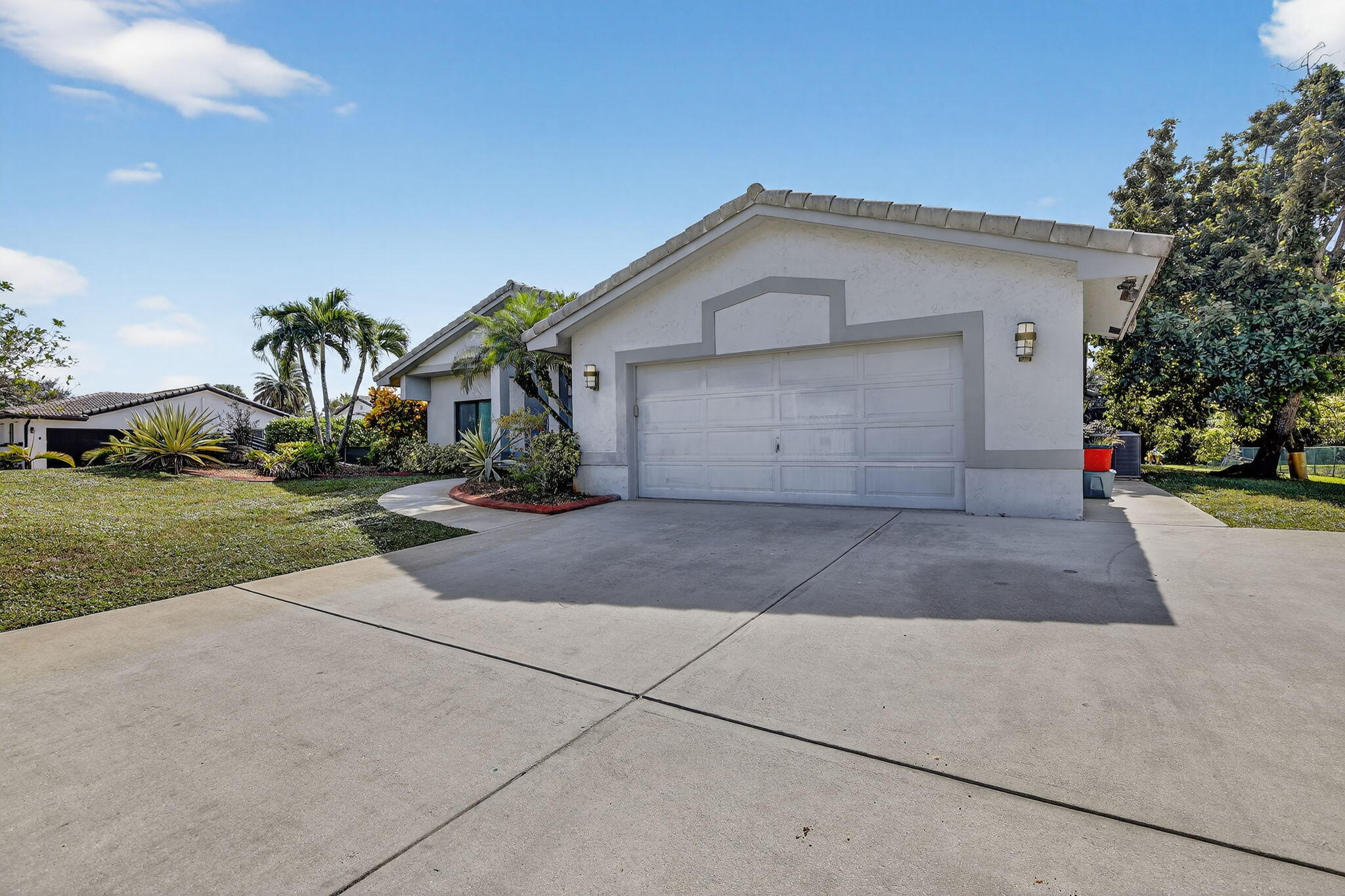 13150 Southwest 16th Court Davie, FL 33325 - Photo 4 of 59 a front view of a house with a yard and garage