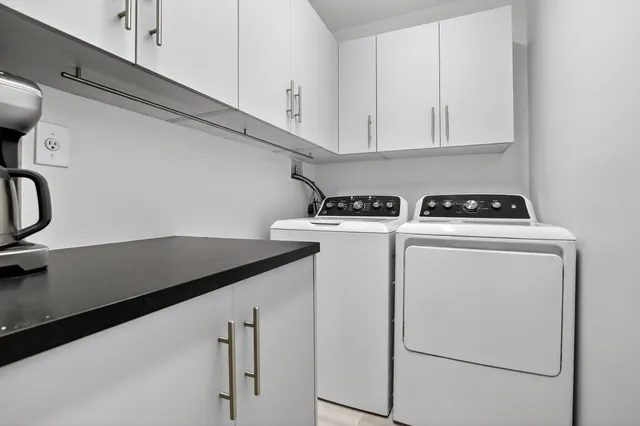 an aerial view of residential houses with outdoor space and trees