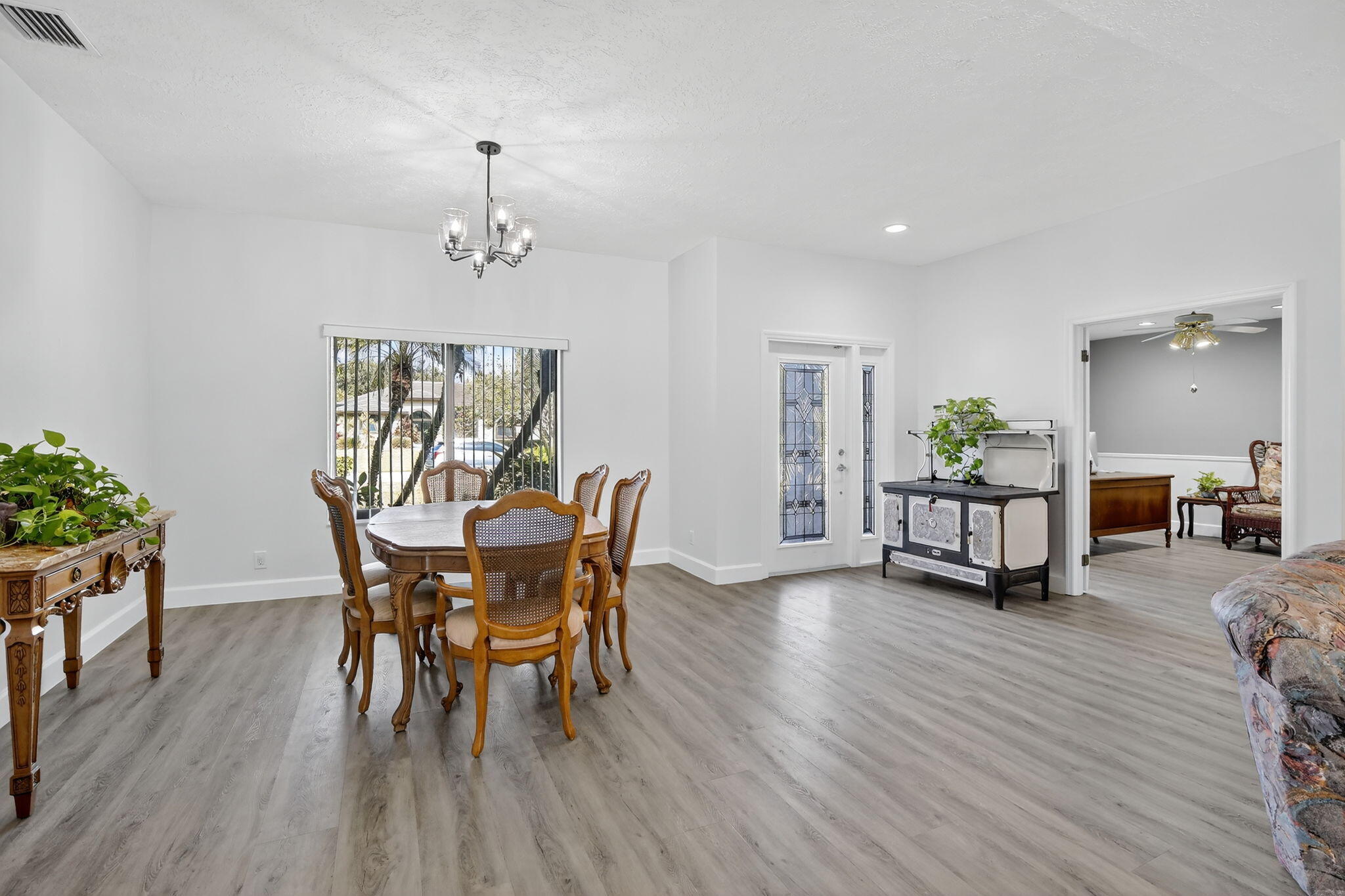 13150 Southwest 16th Court Davie, FL 33325 - Photo 6 of 59 a view of a dining room with furniture and wooden floor