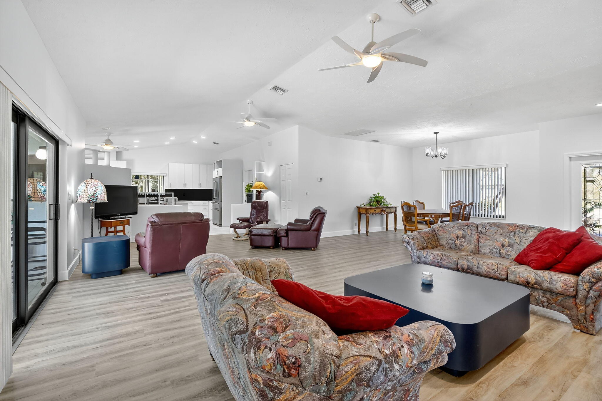 13150 Southwest 16th Court Davie, FL 33325 - Photo 8 of 59 a living room with furniture kitchen area and a wooden floor