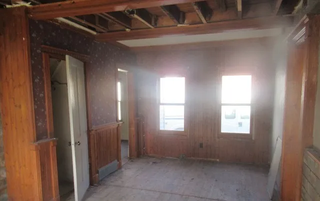 a view of an empty room with windows
