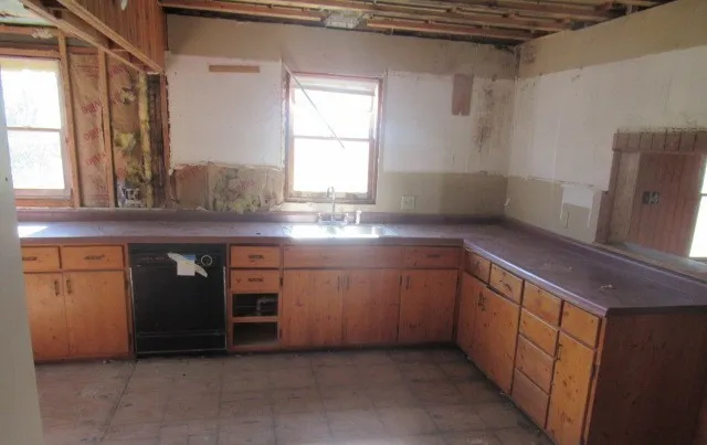 a kitchen with stainless steel appliances granite countertop a sink and a stove