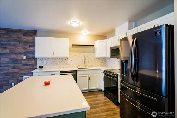 a white refrigerator freezer sitting in a kitchen