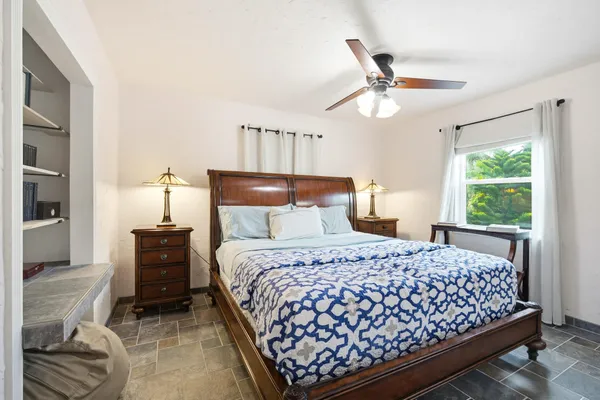 a living room with furniture and a ceiling fan