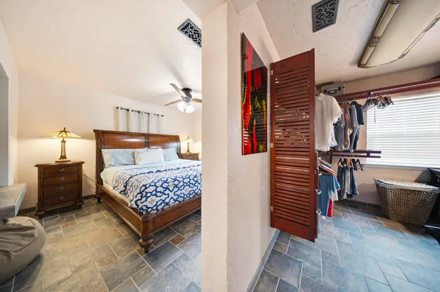 a view of a hallway with wooden floor and furniture