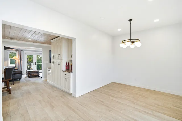 a view of a dining room with furniture wooden floor and chandelier