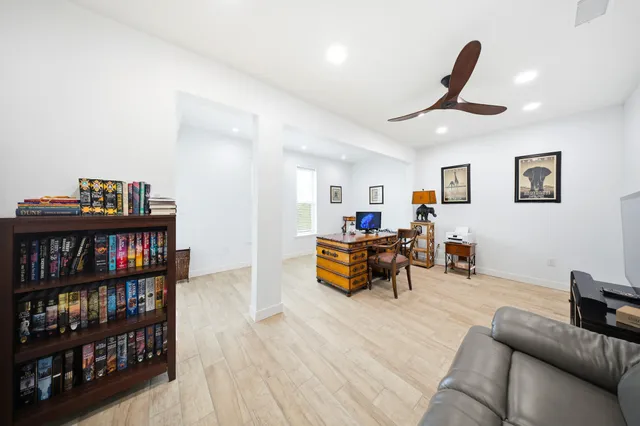 a view of a swimming pool with a table and chairs under an umbrella