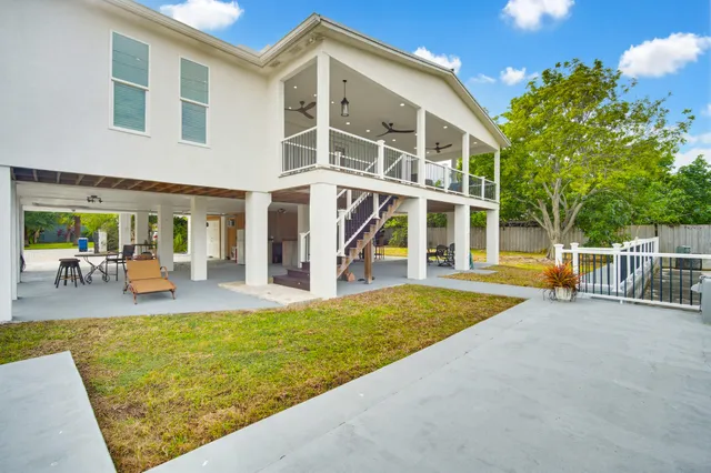an aerial view of a house with a yard lake house swimming pool and outdoor seating