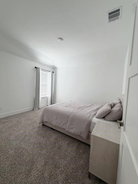 13725 Rising Sun Lane Conroe, TX 77384 - Photo 23 of 29 a bedroom with a bed and wooden floor