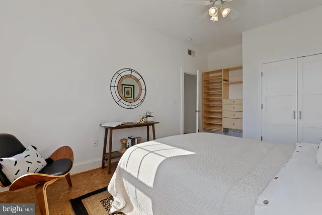 a view of a dining room and livingroom with furniture wooden floor a rug a potted plant and a chandelier