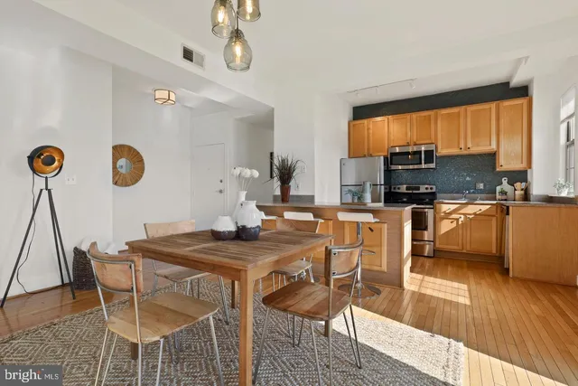 a view of a dining room with furniture and wooden floor
