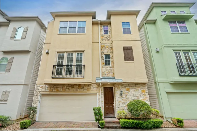 a front view of a house with many windows