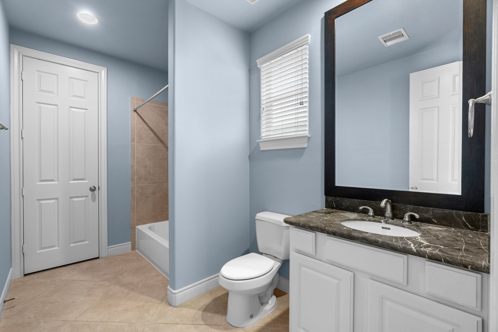 2820 Sherwin Street Houston, TX 77007 - Photo 11 of 50 a bathroom with a granite countertop toilet sink and mirror
