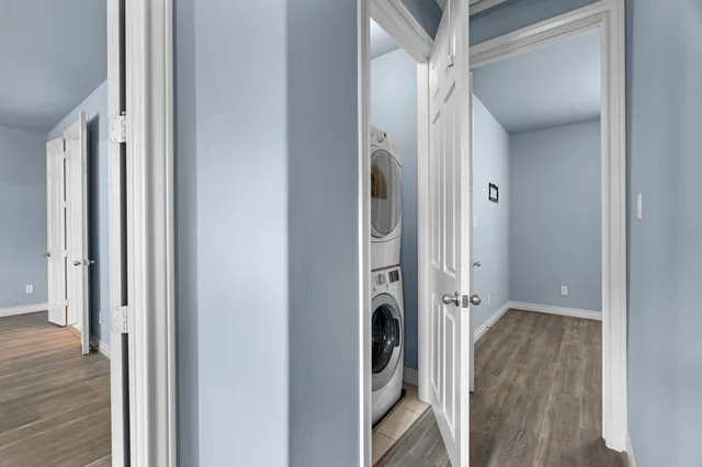 a view of a hallway with wooden floor and entryway