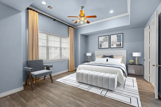 a bedroom with a bed and a chandelier