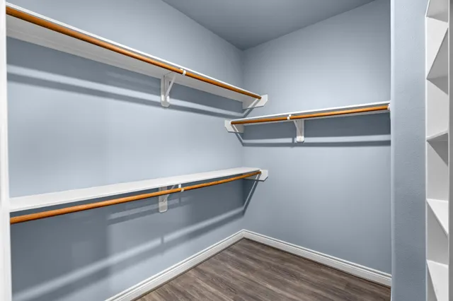 a room with a wooden floor and a window