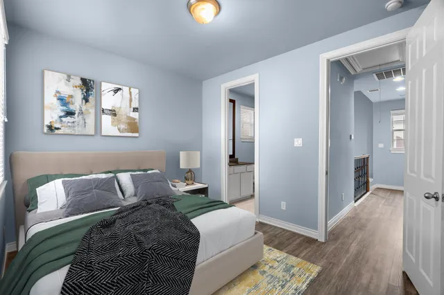 a bedroom with a bed and painting on the wall