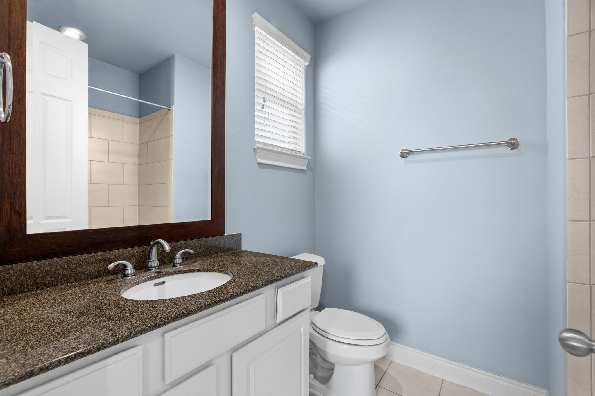 2820 Sherwin Street Houston, TX 77007 - Photo 48 of 50 a bathroom with a granite countertop sink toilet and a mirror