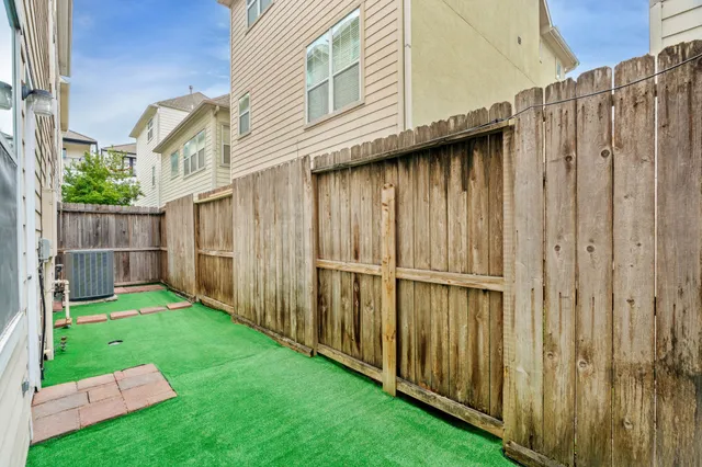 a view of a backyard with wooden fence