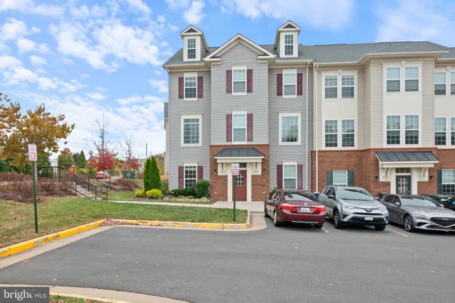 a view of a car parked in front of a brick house