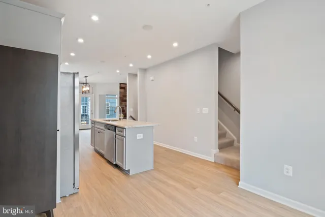 a kitchen with stainless steel appliances granite countertop a refrigerator and a sink